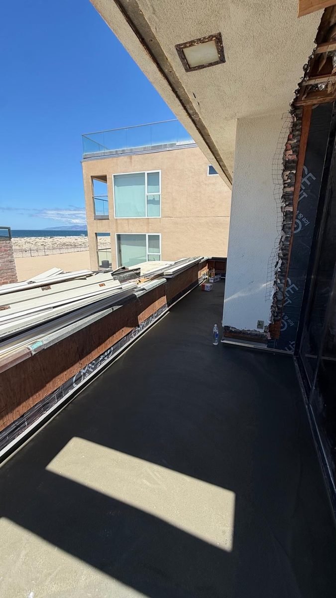Oceanfront balcony and deck rebuild in progress in Malibu with structural framing
